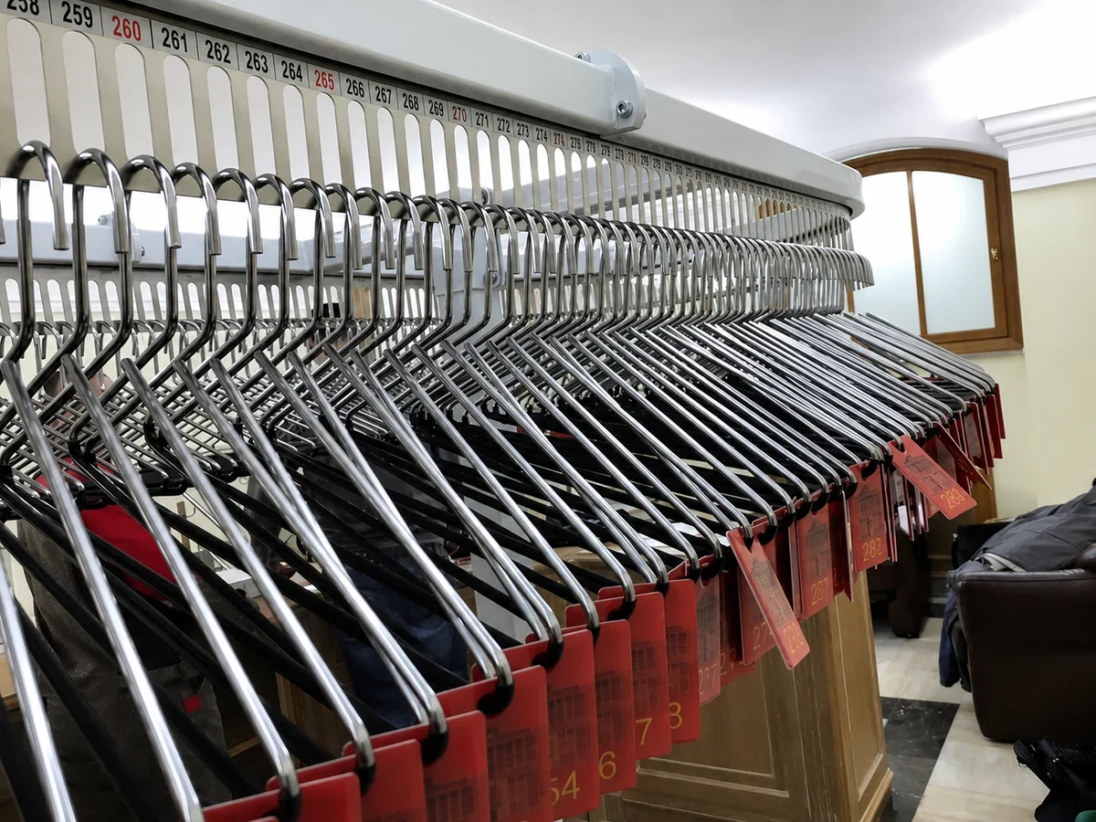 automated garment conveyor workflow: Numbered garment conveyor positions for organized retrieval